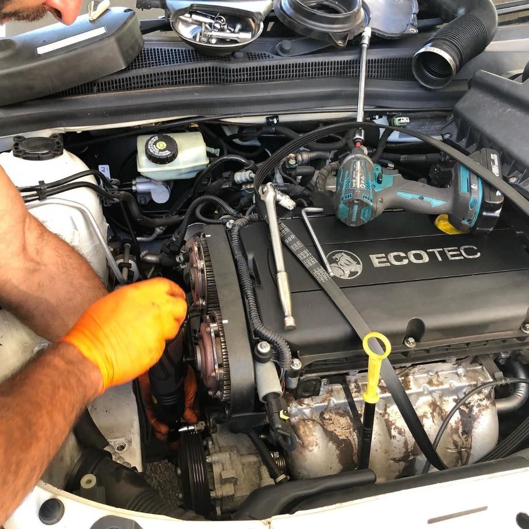 A Man Wearing Orange Gloves Is Working On A Ecotec Engine — SG Mobile Mechanic In Newcastle, NSW