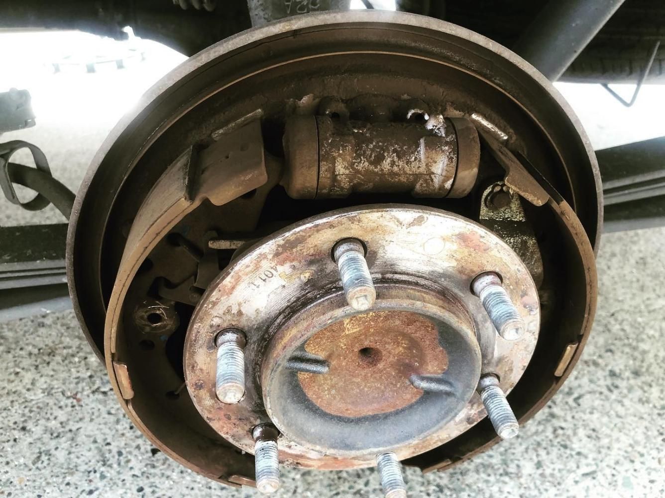 A Close Up Of A Rusty Break Pad Wheel On A Car — SG Mobile Mechanic In Newcastle, NSW
