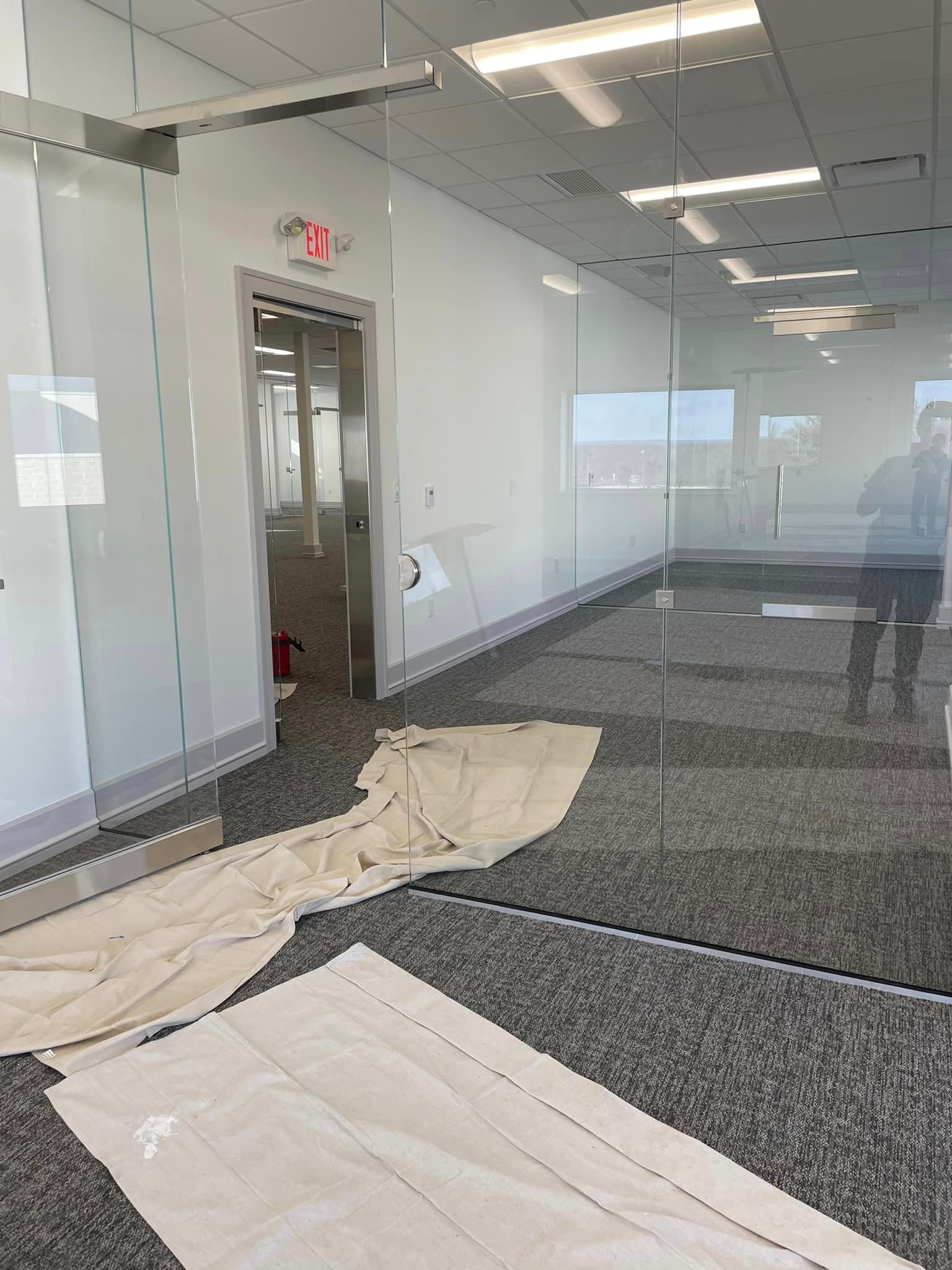 A large empty room with a lot of glass walls.
