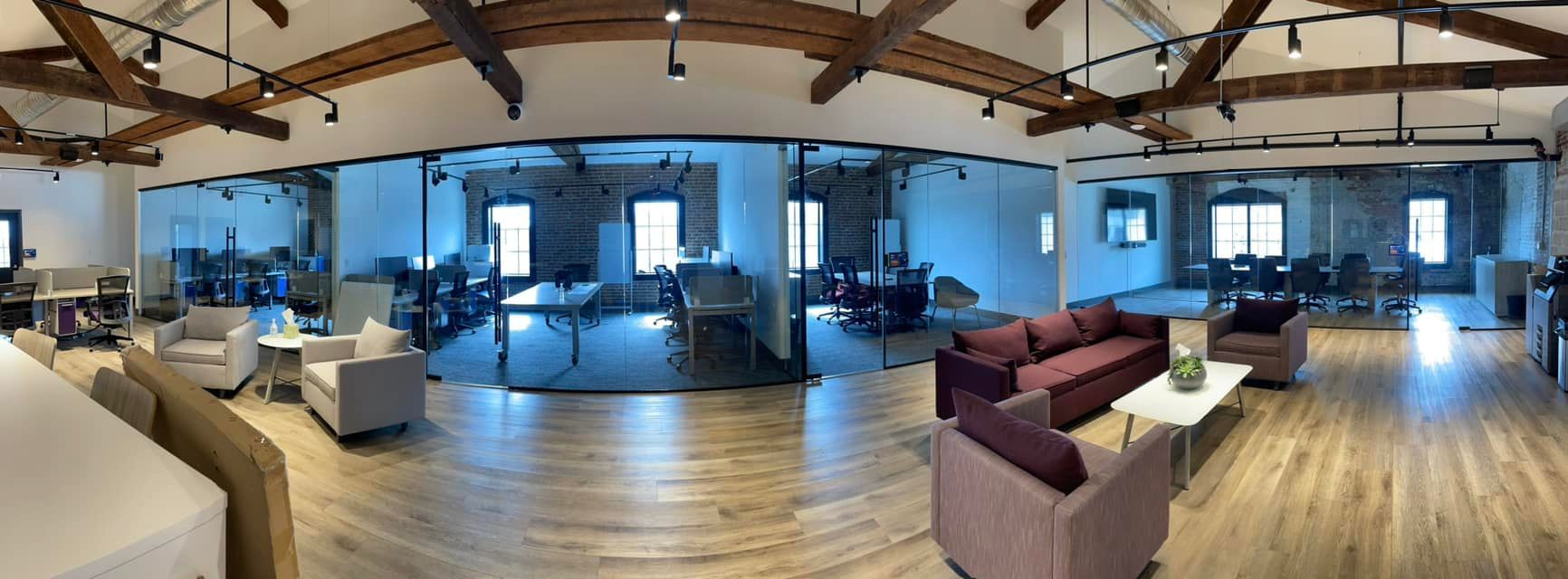 A large room with a couch and chairs in it.