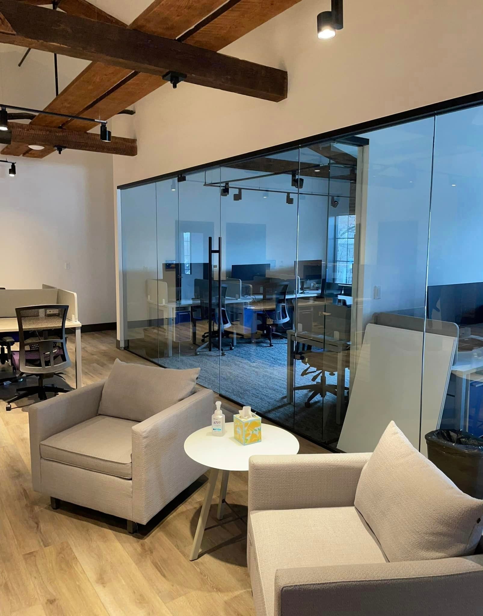 There are two chairs and a table in the room.