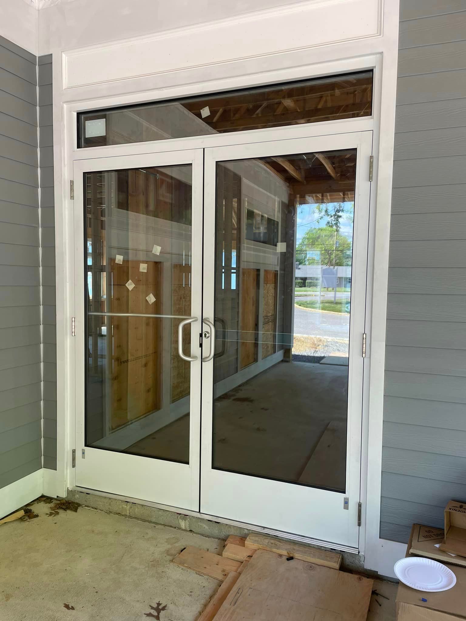 A white door with a lot of glass is sitting in a room.