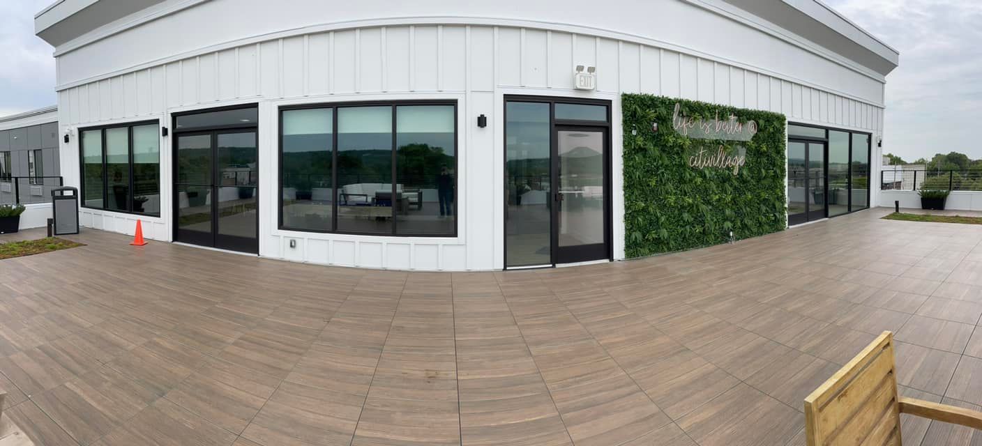 A large white building with a wooden deck in front of it.