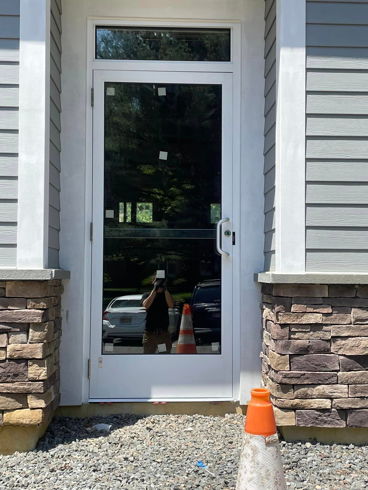 A white door with a reflection of a car in it