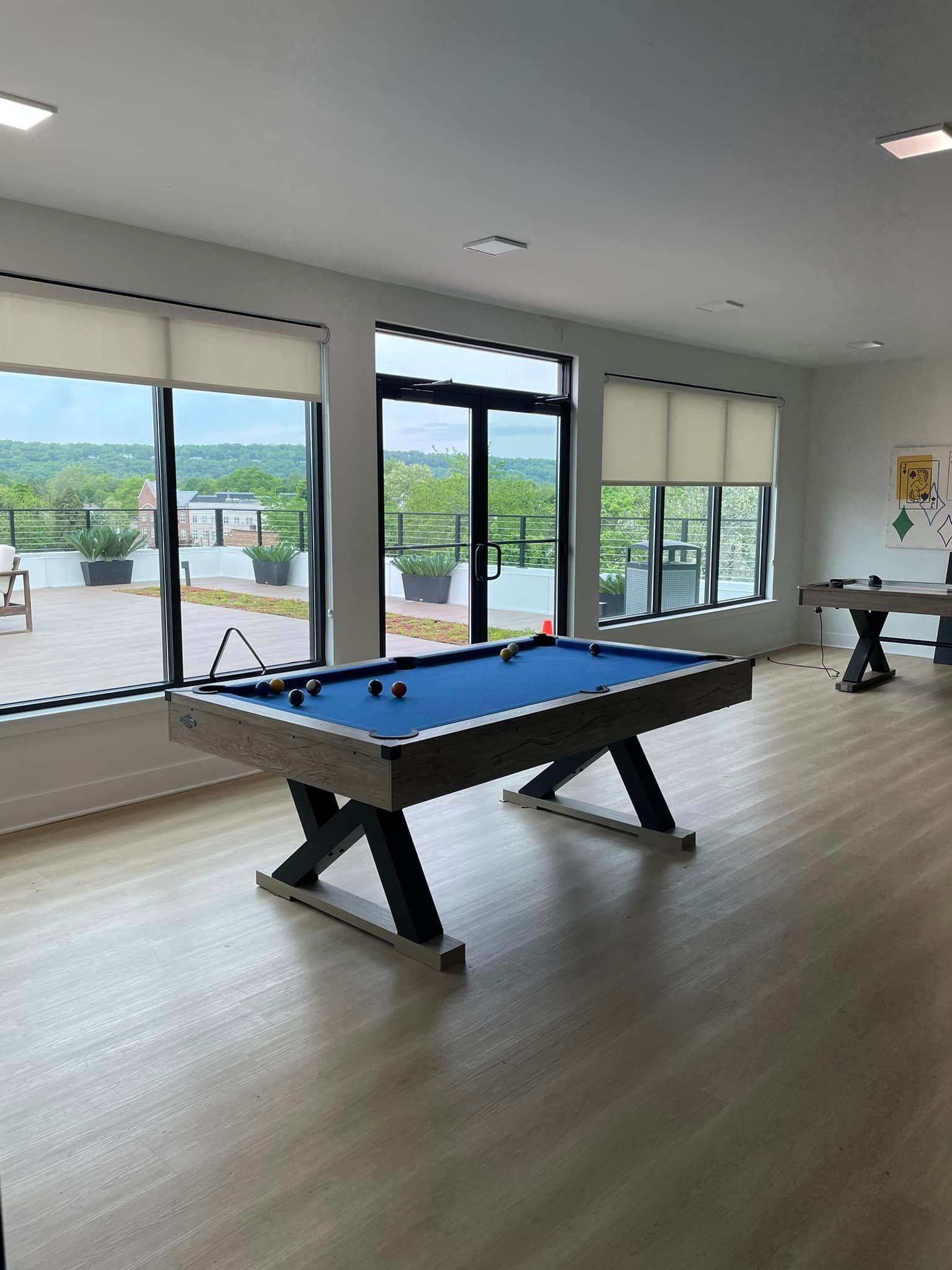 There is a pool table in the middle of the room.