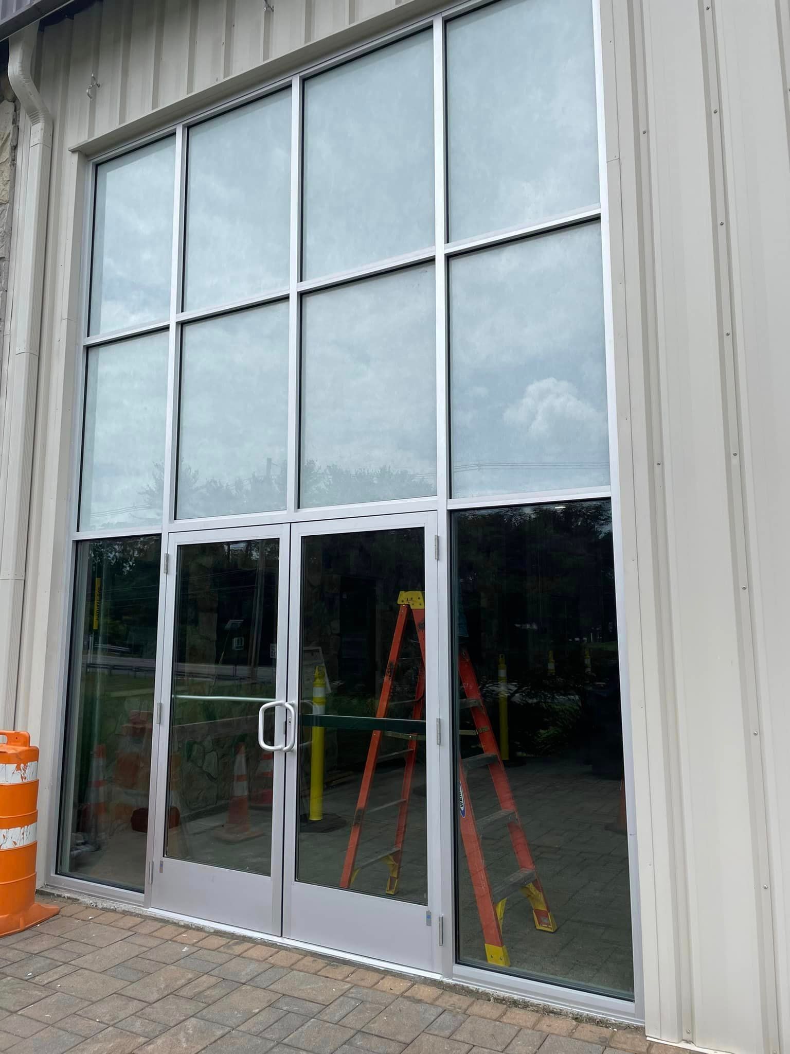 A large building with a lot of windows and a ladder in front of it.
