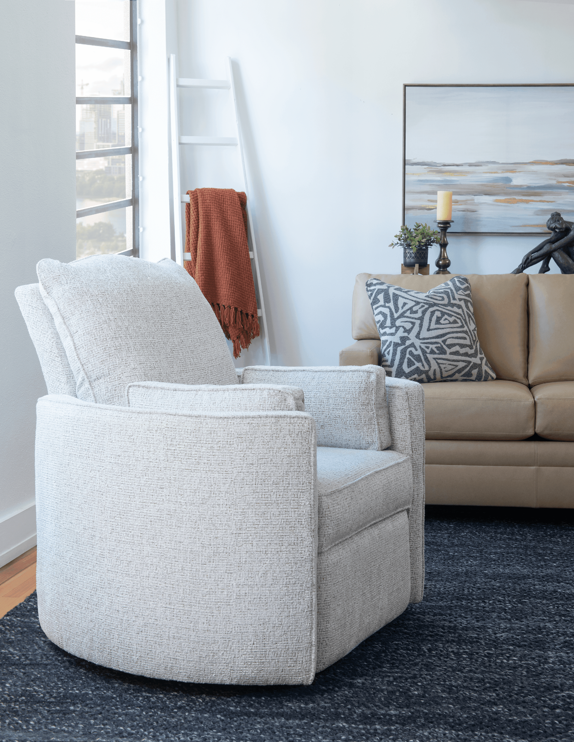 White textured armchair in a bright living room with beige sofa and dark rug.