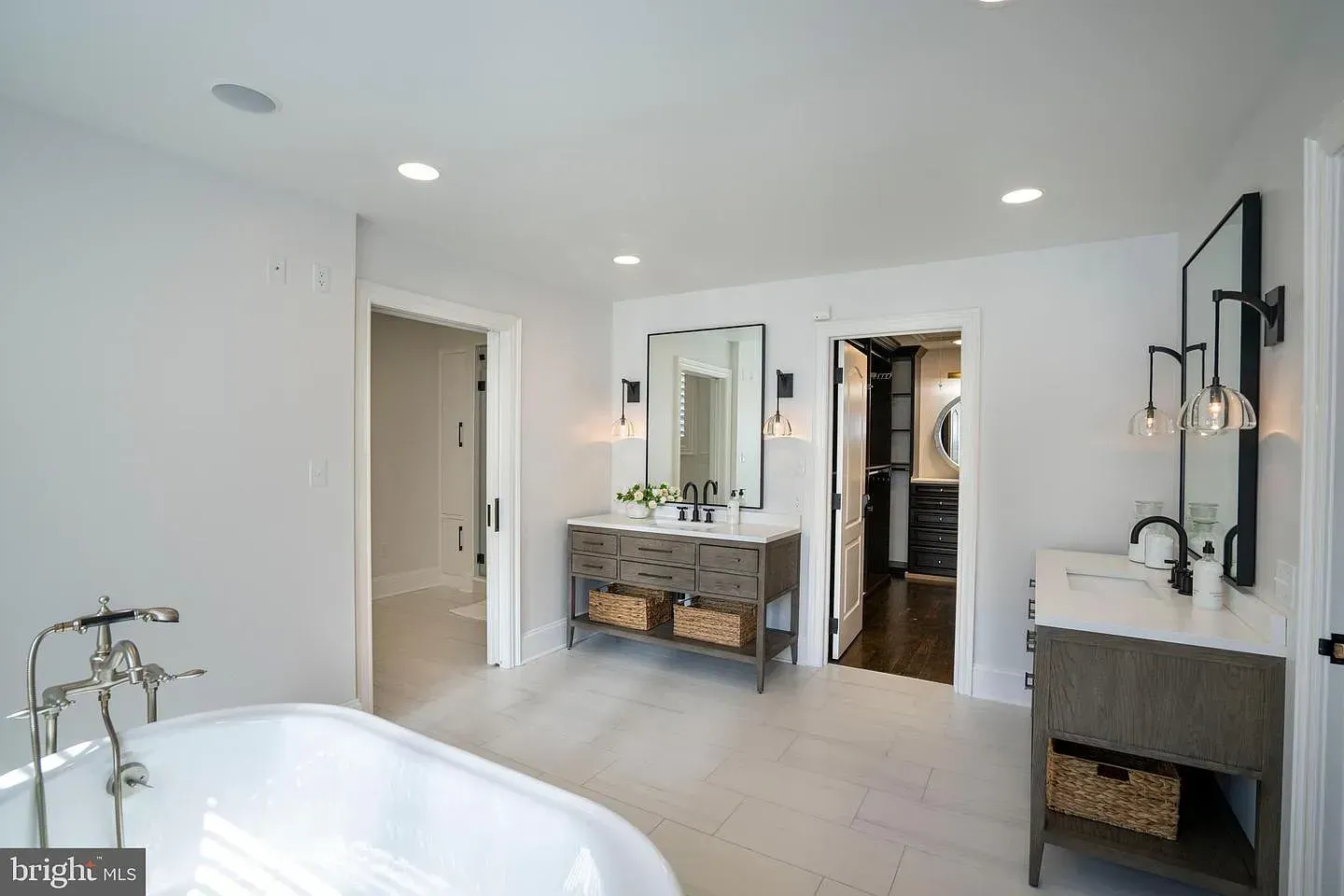 Bright modern bathroom with freestanding tub, double vanity, and walk-in shower.