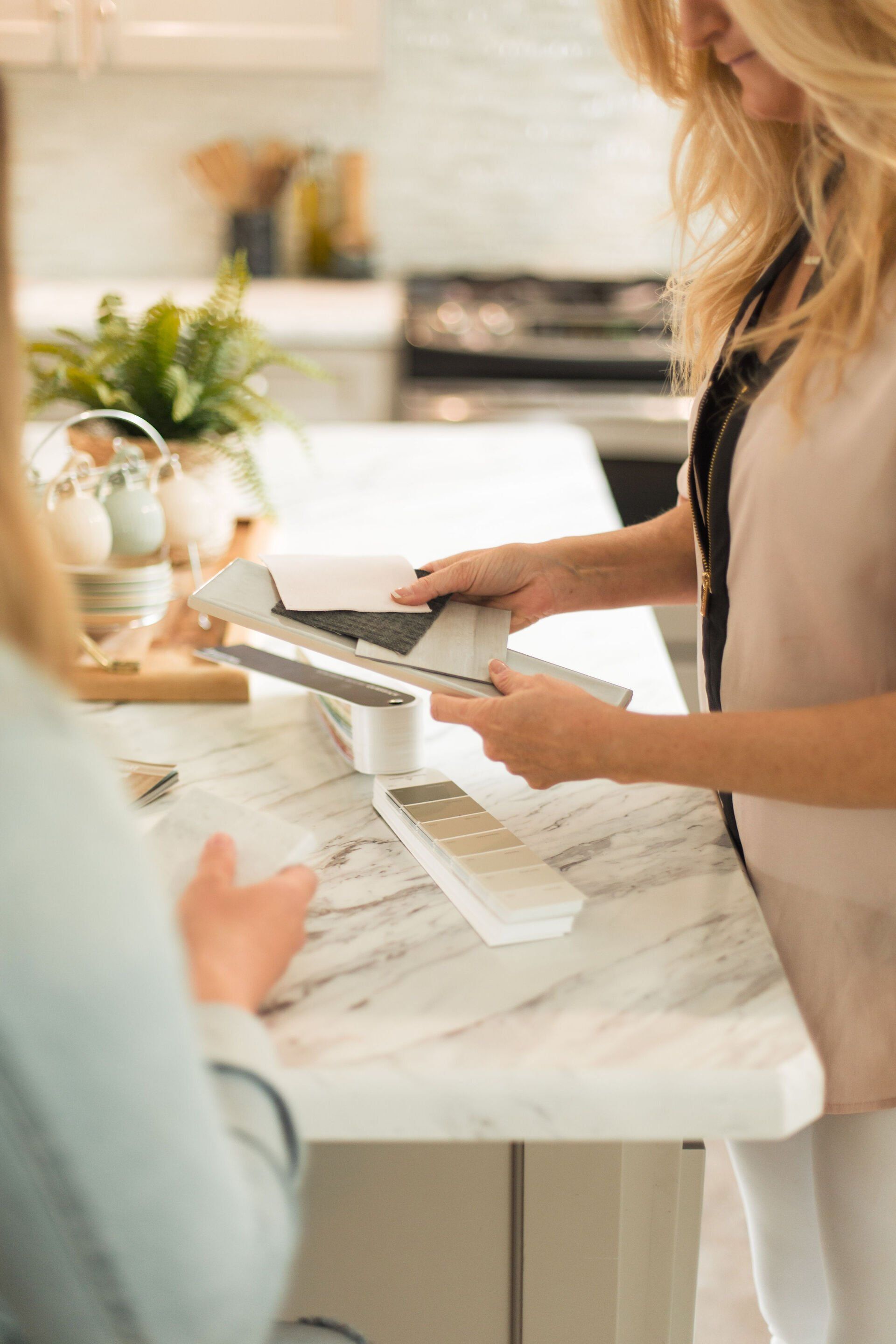 Person using a card reader to pay at a kitchen counter with a smartphone and receipt printer