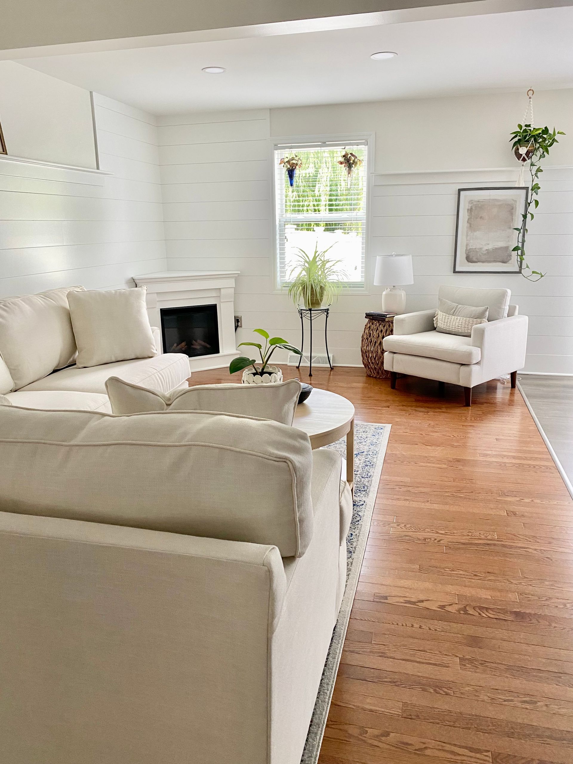 a living room renovation by Christy Martin Design Interiors filled with furniture and a fireplace .