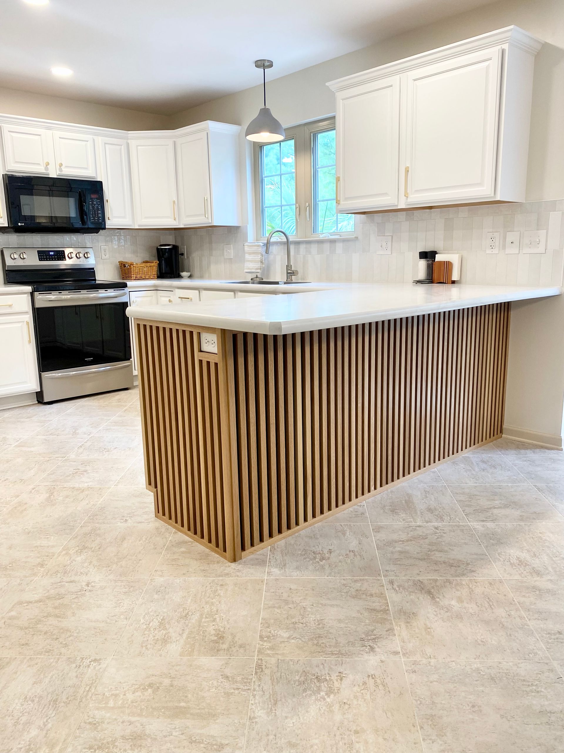 a kitchen with a large wooden island in the middle .