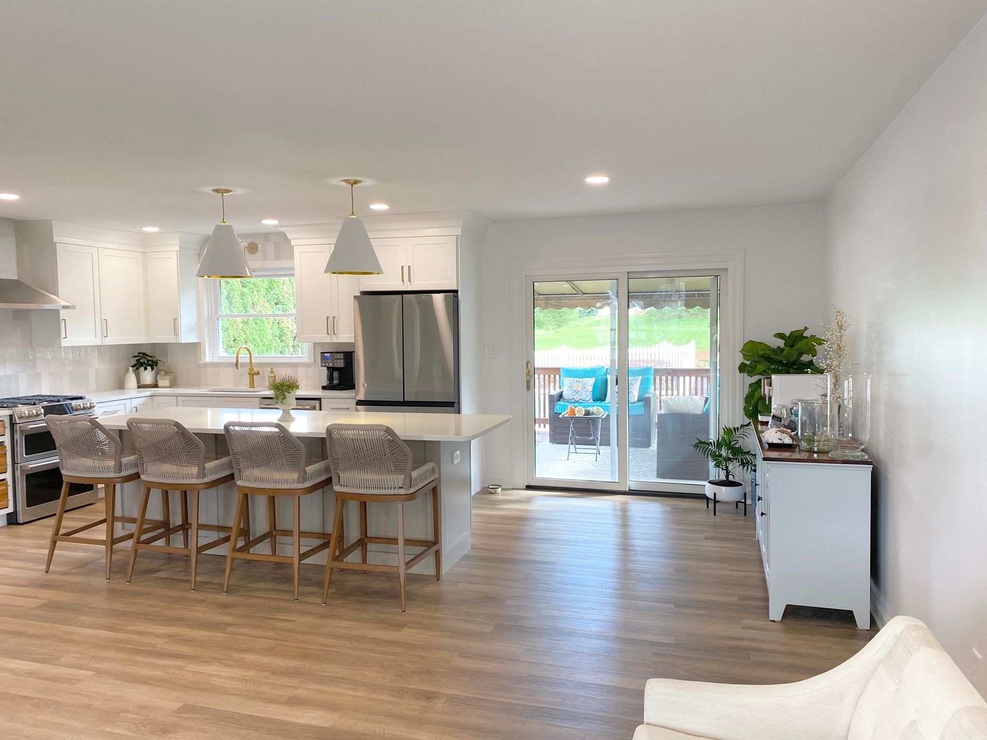 a custom kitchen remodel in Lancaster PA with a large island and stools in a living room .
