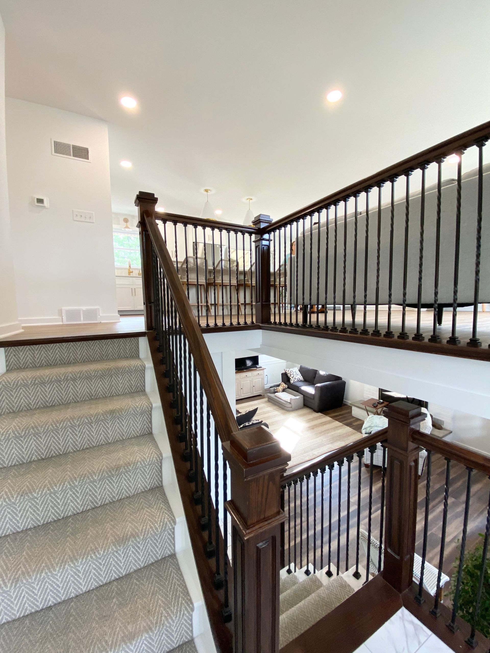a staircase leading up to a living room in a house .