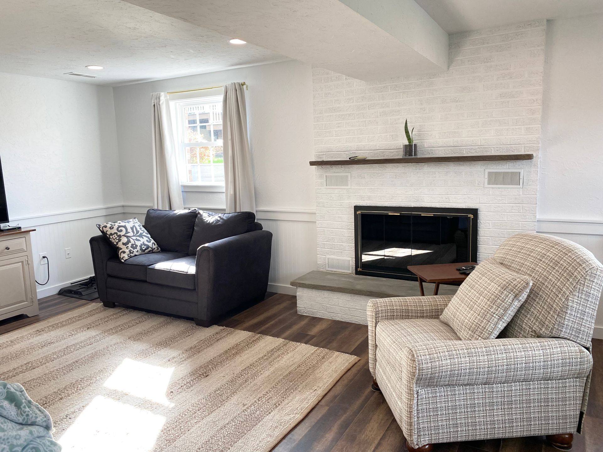 a living room renovation by Christy Martin Design Interiors, featuring a custom couch, chairs, and ottoman