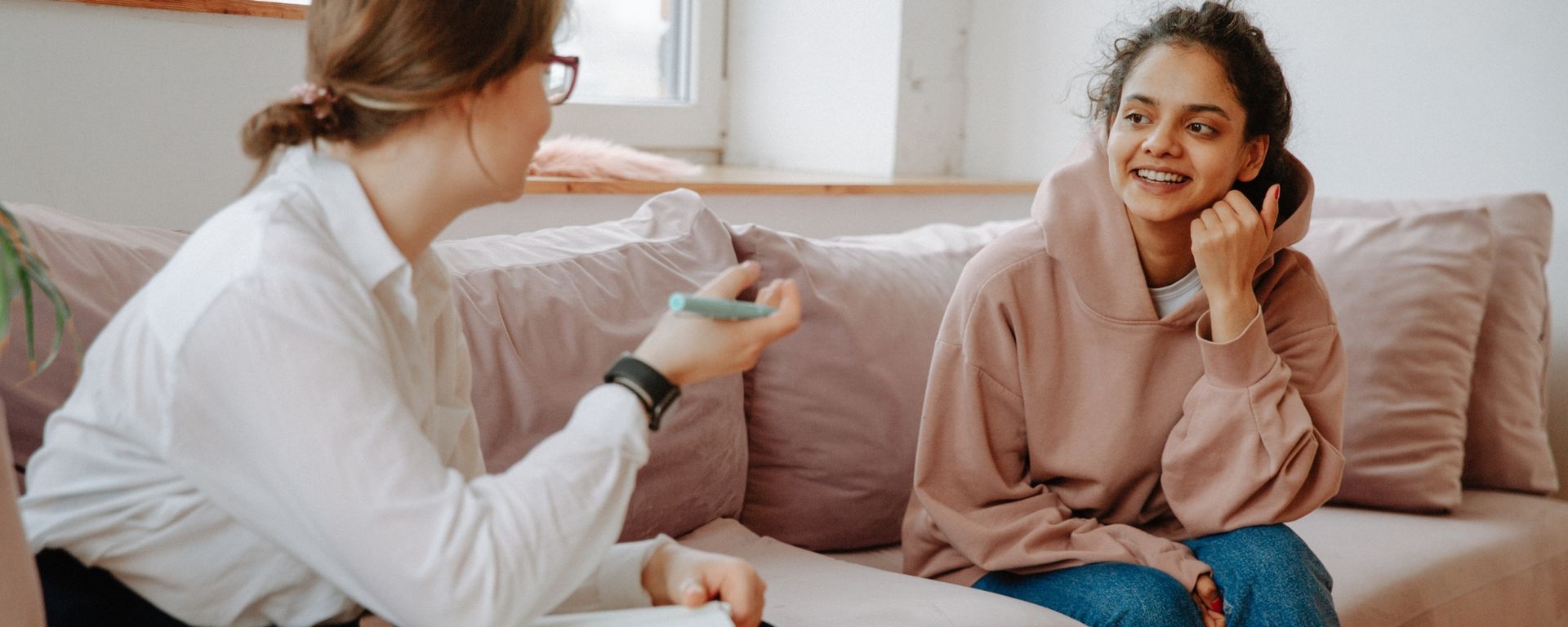 female psychologist talking to young patient