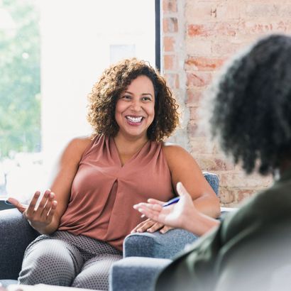 Female counsellor on chair sitting across patient