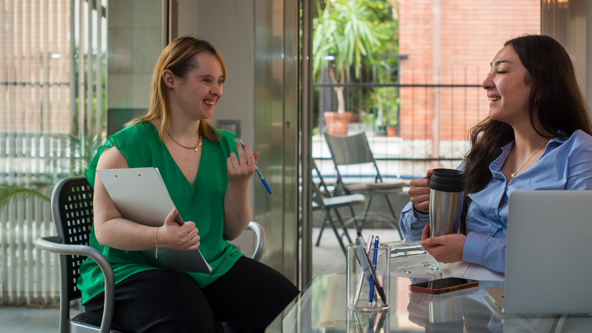 Woman with disability talking to another woman