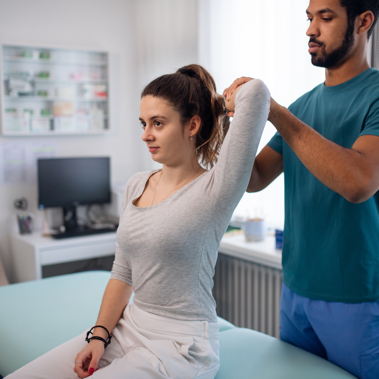 Male occupational therapist helping female patient