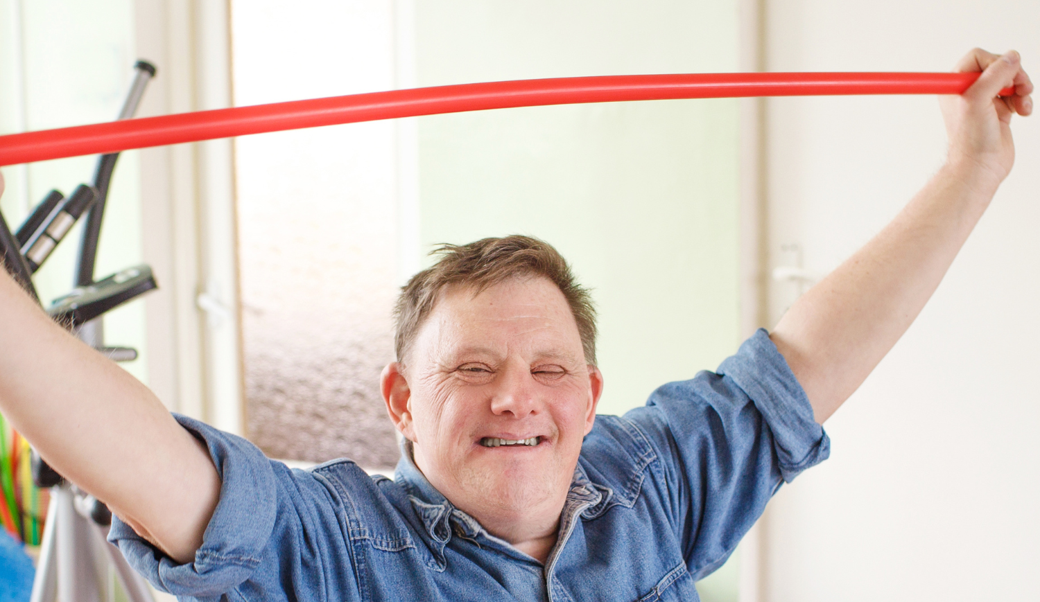 man with disability holding a physiotherapy tool