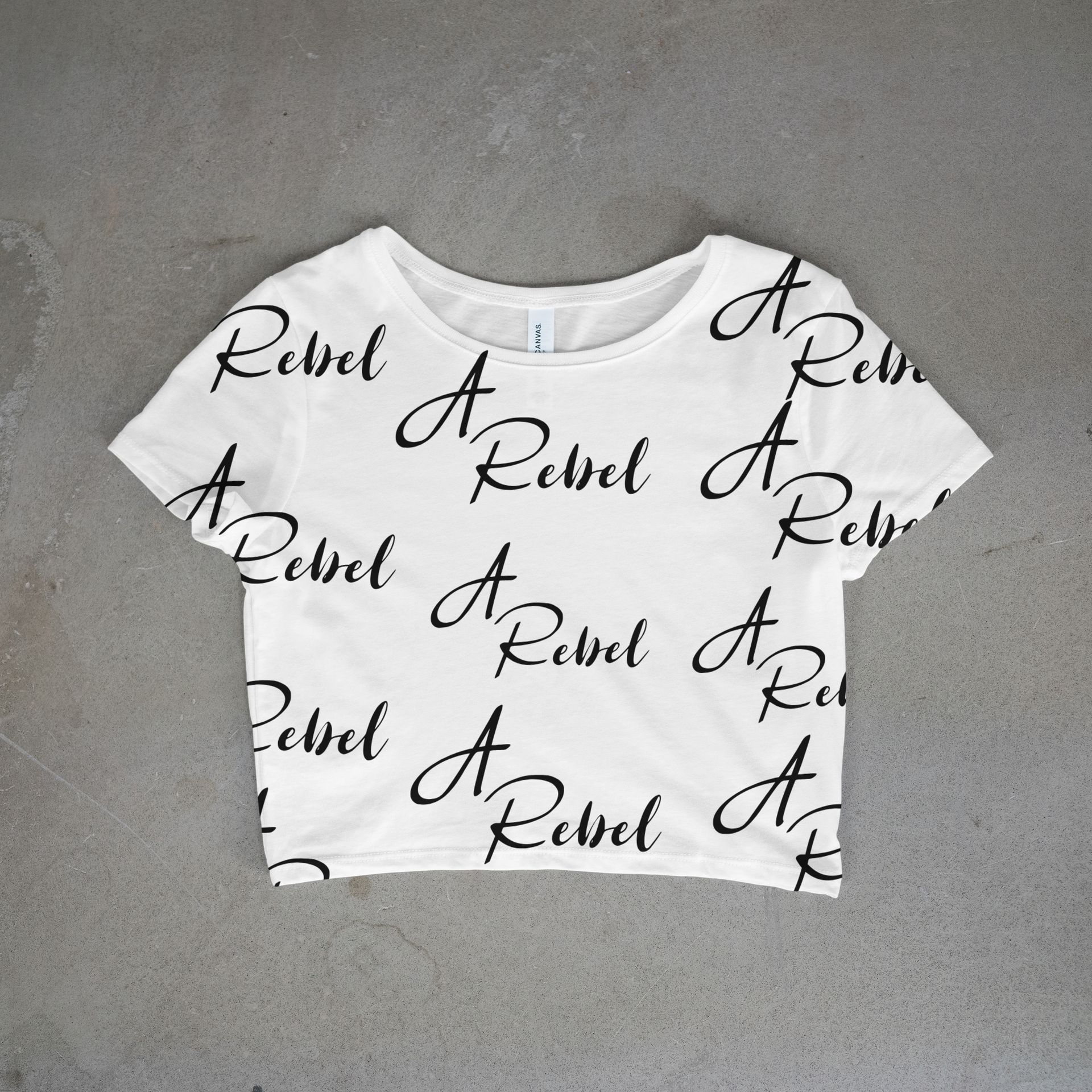 White cropped t-shirt  with black cursive saying A Rebel all over front and back 