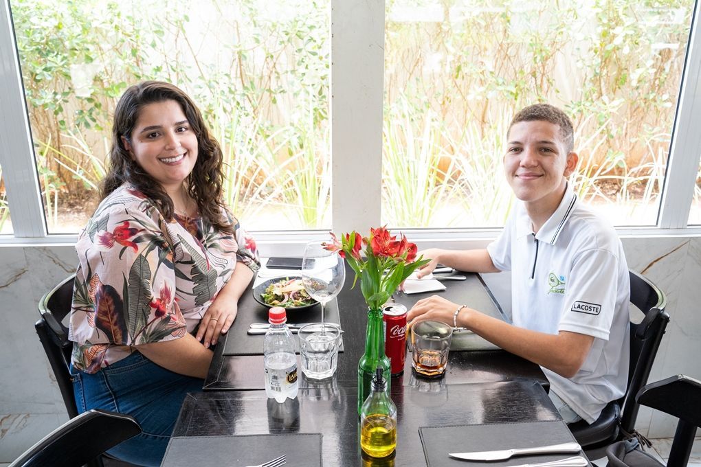 Um homem e uma mulher estão sentados à mesa em um restaurante.