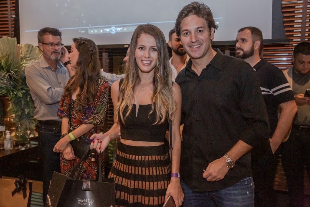 Um homem e uma mulher estão posando para uma foto em uma festa.