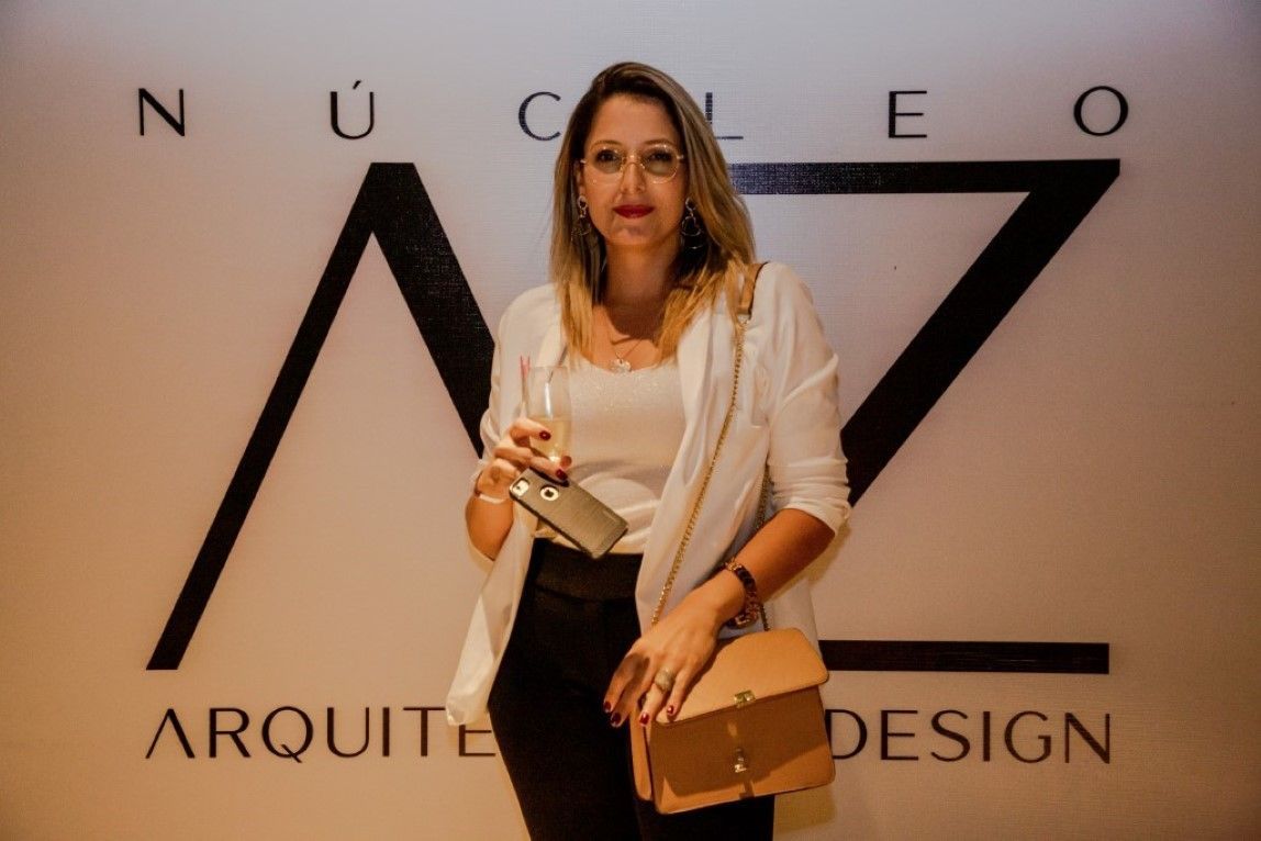 Uma mulher está parada em frente a uma placa que diz arquiteto design