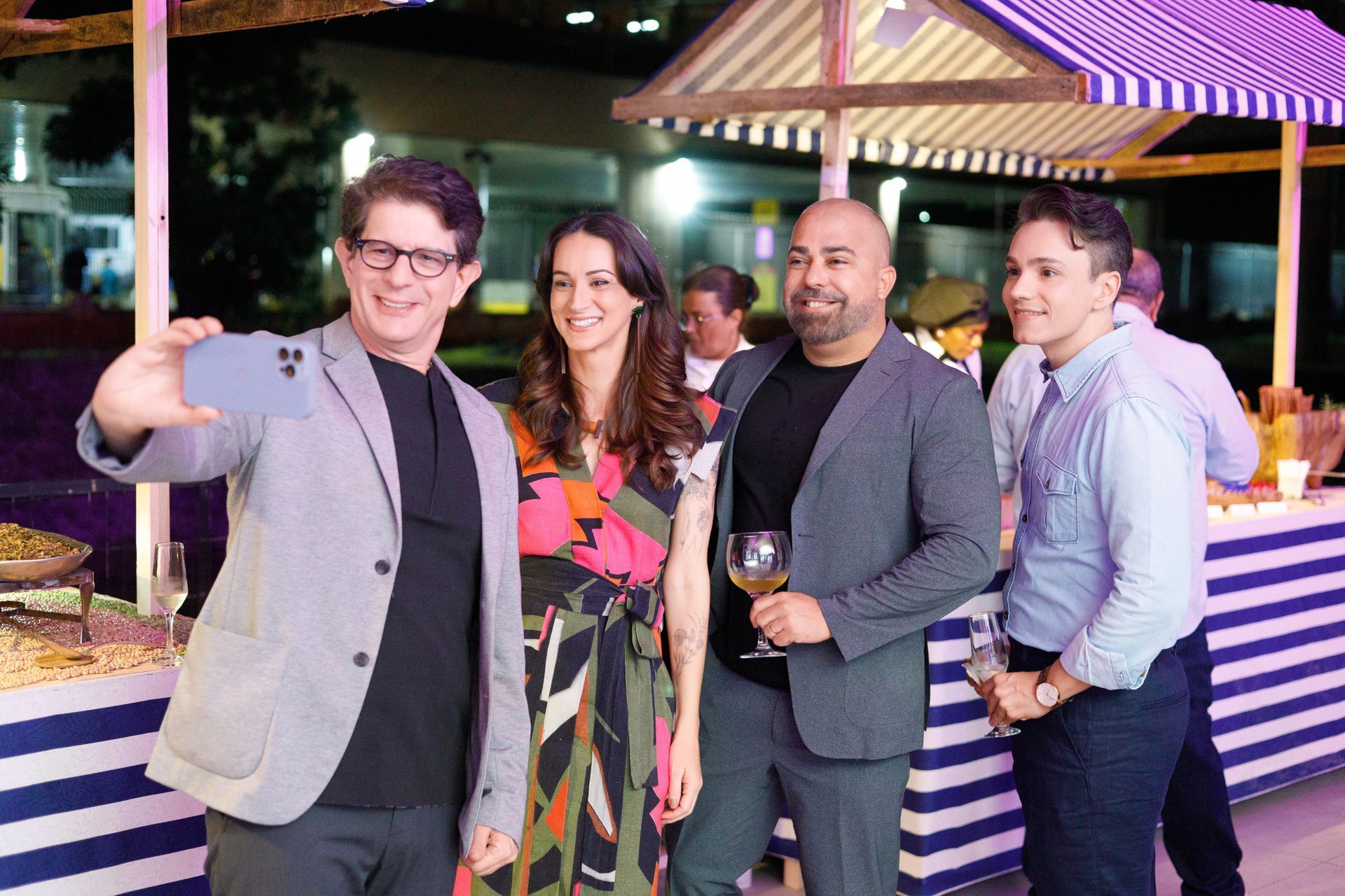 Um grupo de pessoas está posando para uma foto em uma festa.