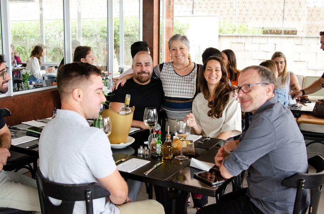 Um grupo de pessoas está sentado em mesas em um restaurante.