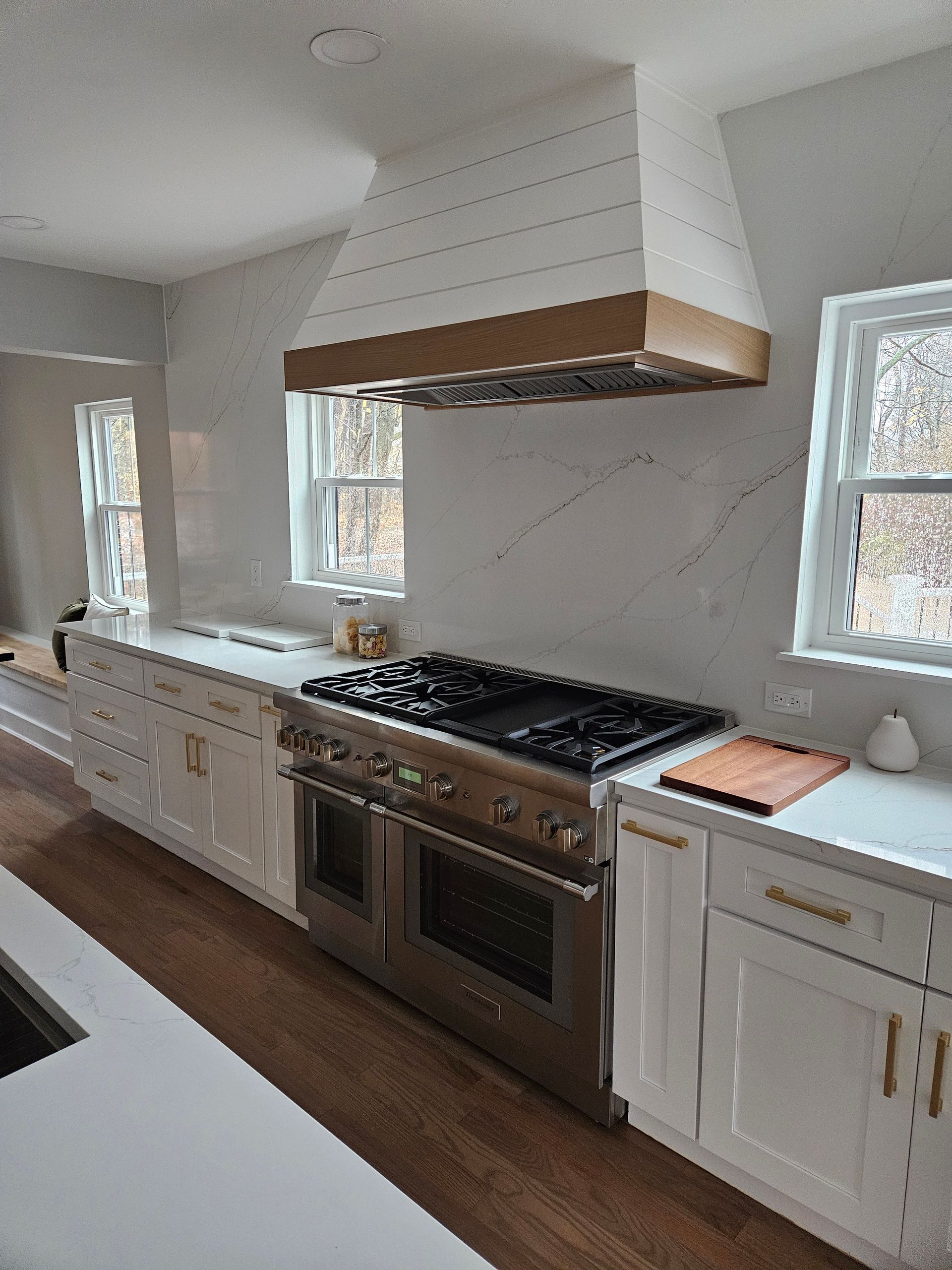 Modern kitchen with dark wood cabinets, stainless steel appliances, and white subway tile backsplash.
