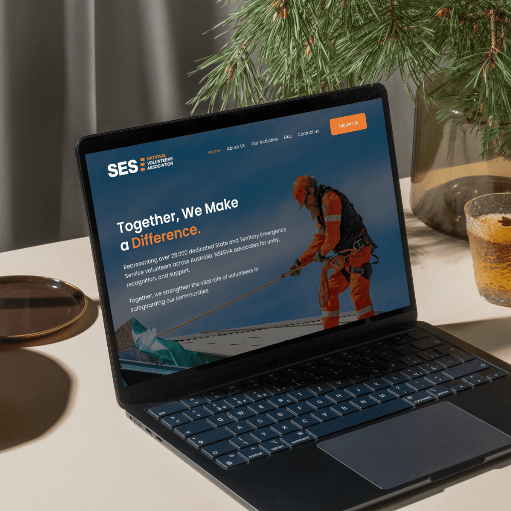 A laptop sits on a table, displaying a website with an industrial worker using equipment on a roof.