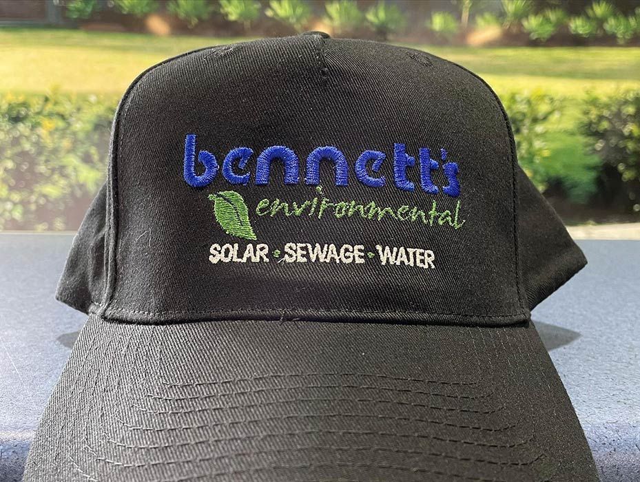 A Black Baseball Cap With The Words Bennett Environmental Solar Sewage Water Embroidered On It — Bennett's Environmental In Southern Highlands, NSW