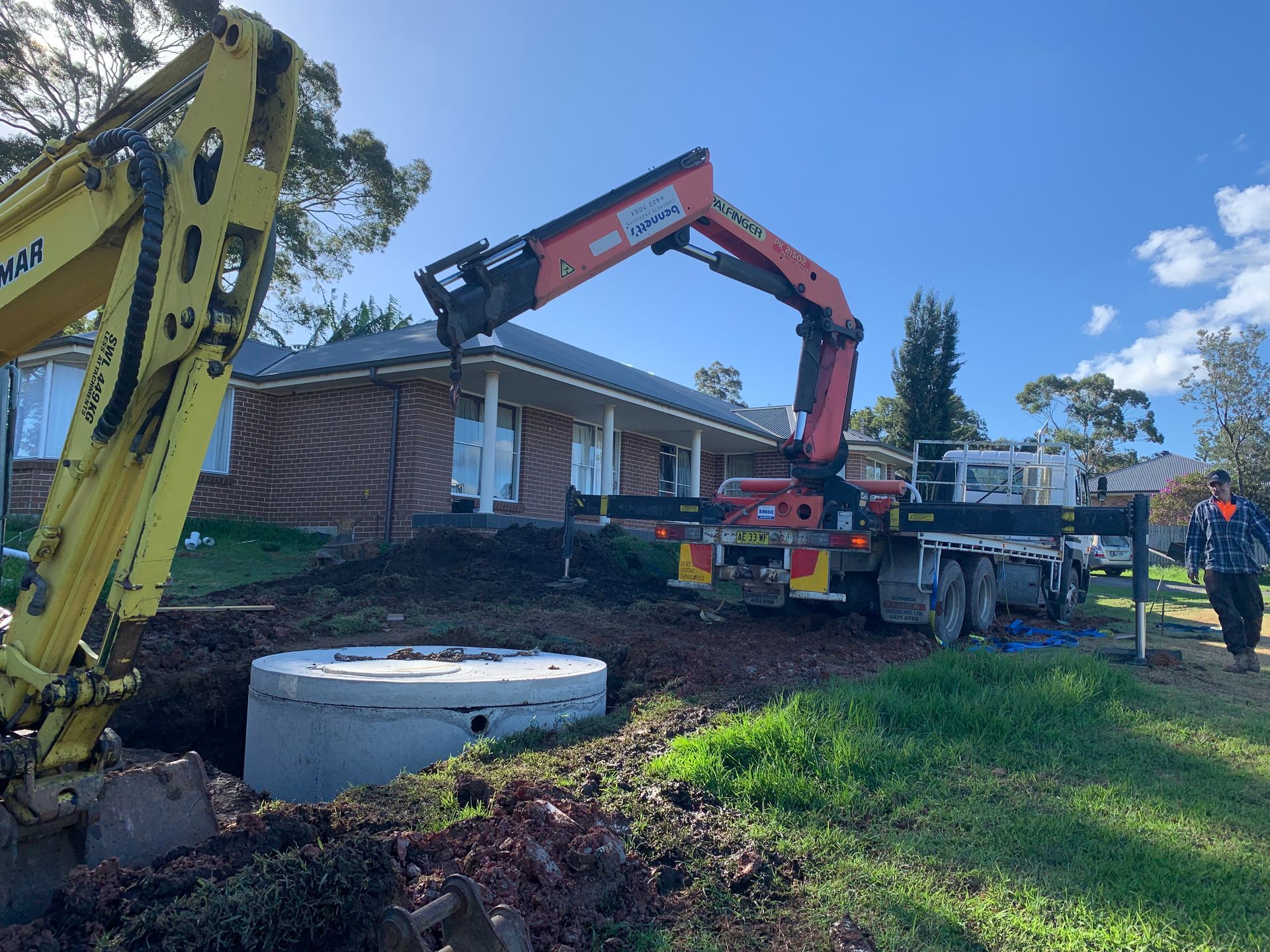 A Septic Tank Is Sitting In The Middle Of A Lush Green Yard — Bennett's Environmental In Wollongong, NSW