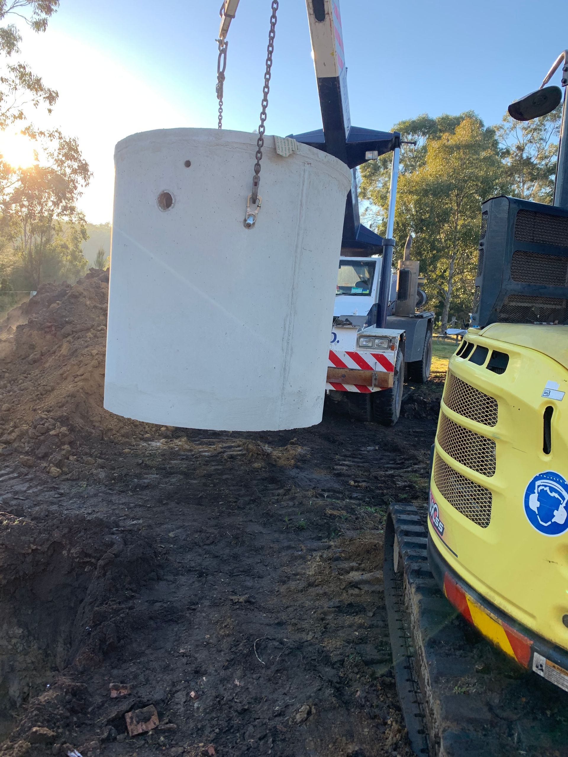 A Crane Carrying Concrete Septic Tank — Bennett's Environmental In South Nowra, NSW