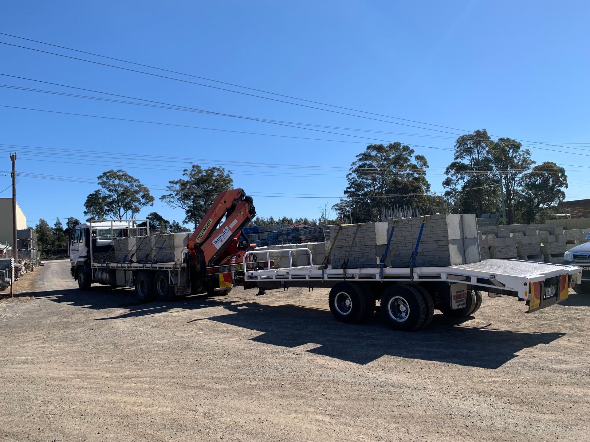 Flat Bed Truck With Crane At Back Carrying Concrete Slabs — Bennett's Environmental In Shellharbour, NSW