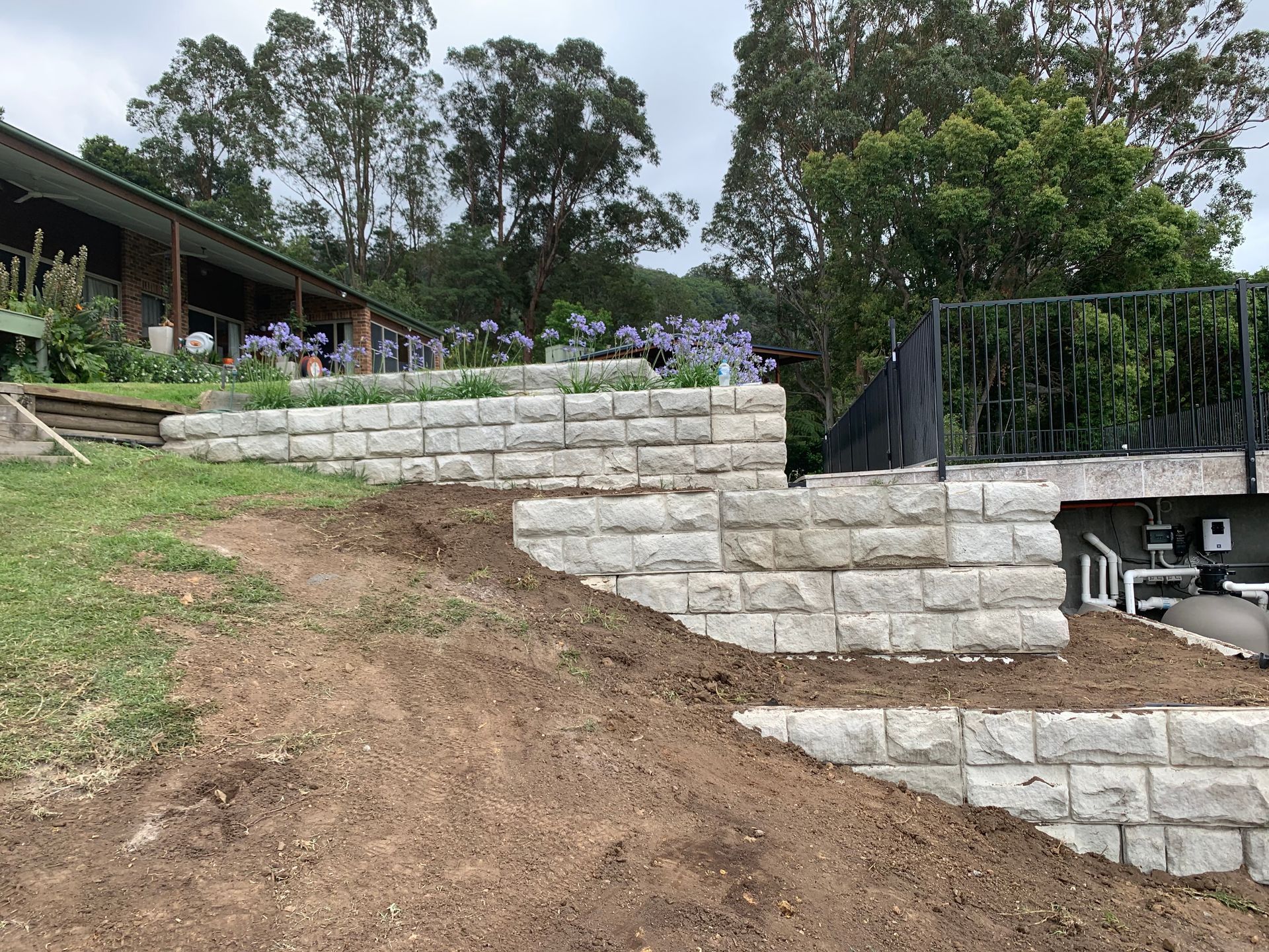 Concrete Retaining Wall On Dirt Hill — Bennett's Environmental In Wollongong, NSW