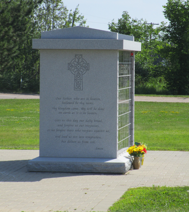 A stone memorial with a cross on it