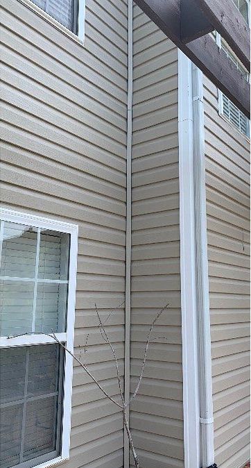 The side of a house with siding and a window.