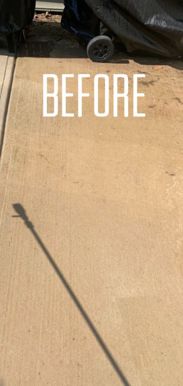 A picture of a concrete sidewalk before being cleaned.