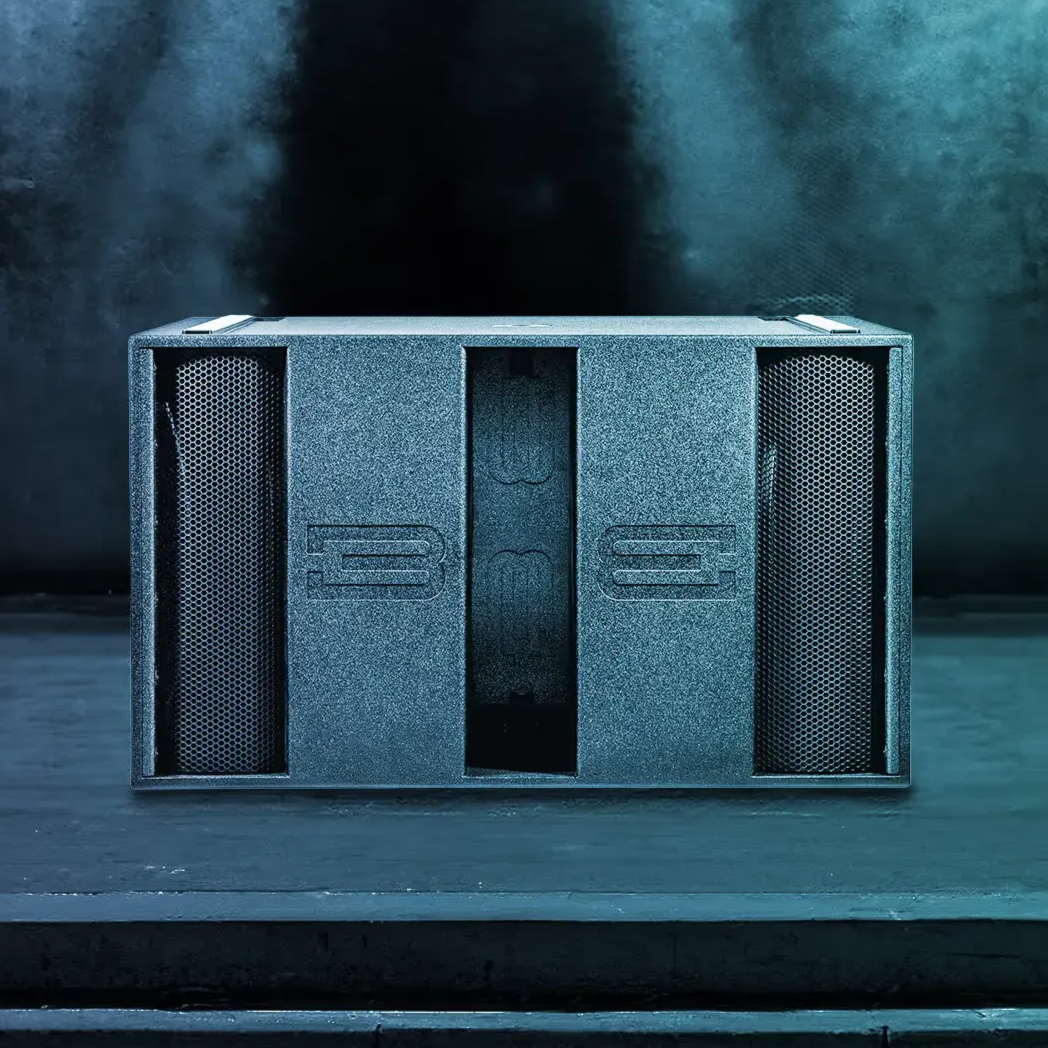 Black speaker on green grass outdoors with a metal grill, logo at the top.