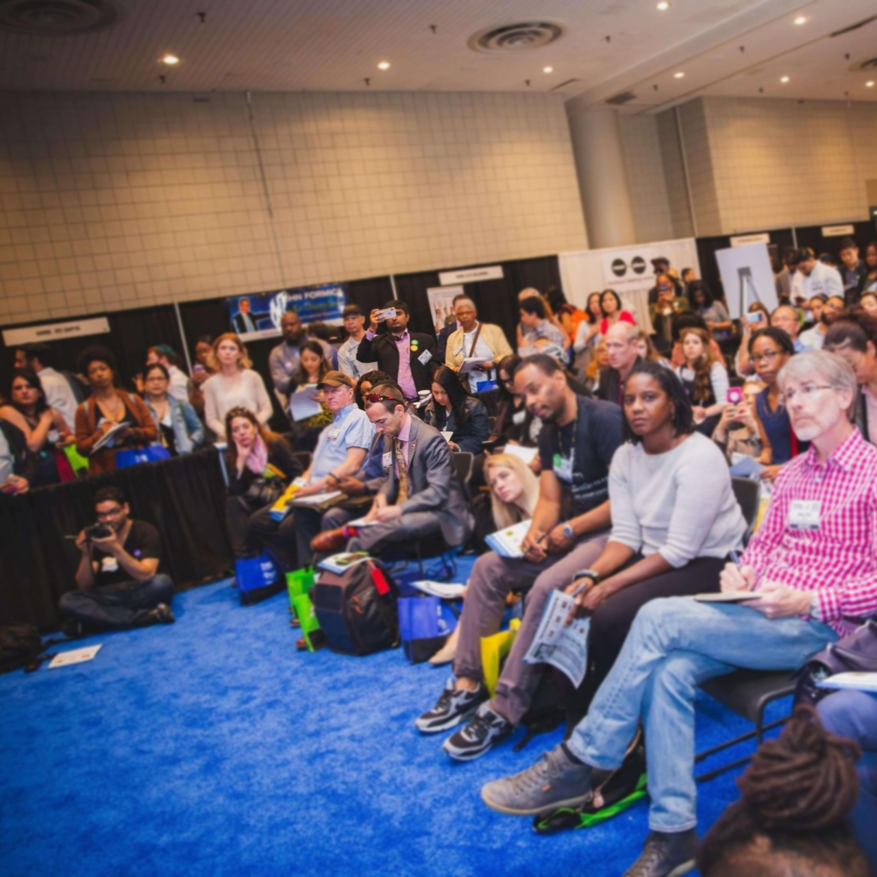 A large group of people are sitting in a room.