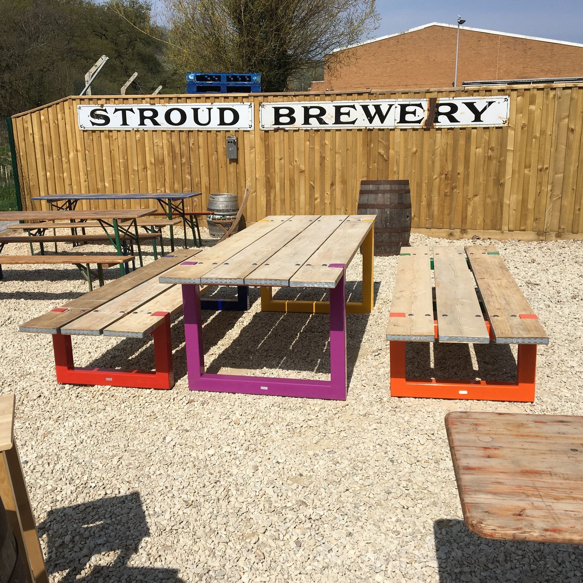 Stroud Brewery outdoor seating area with colorful picnic tables.