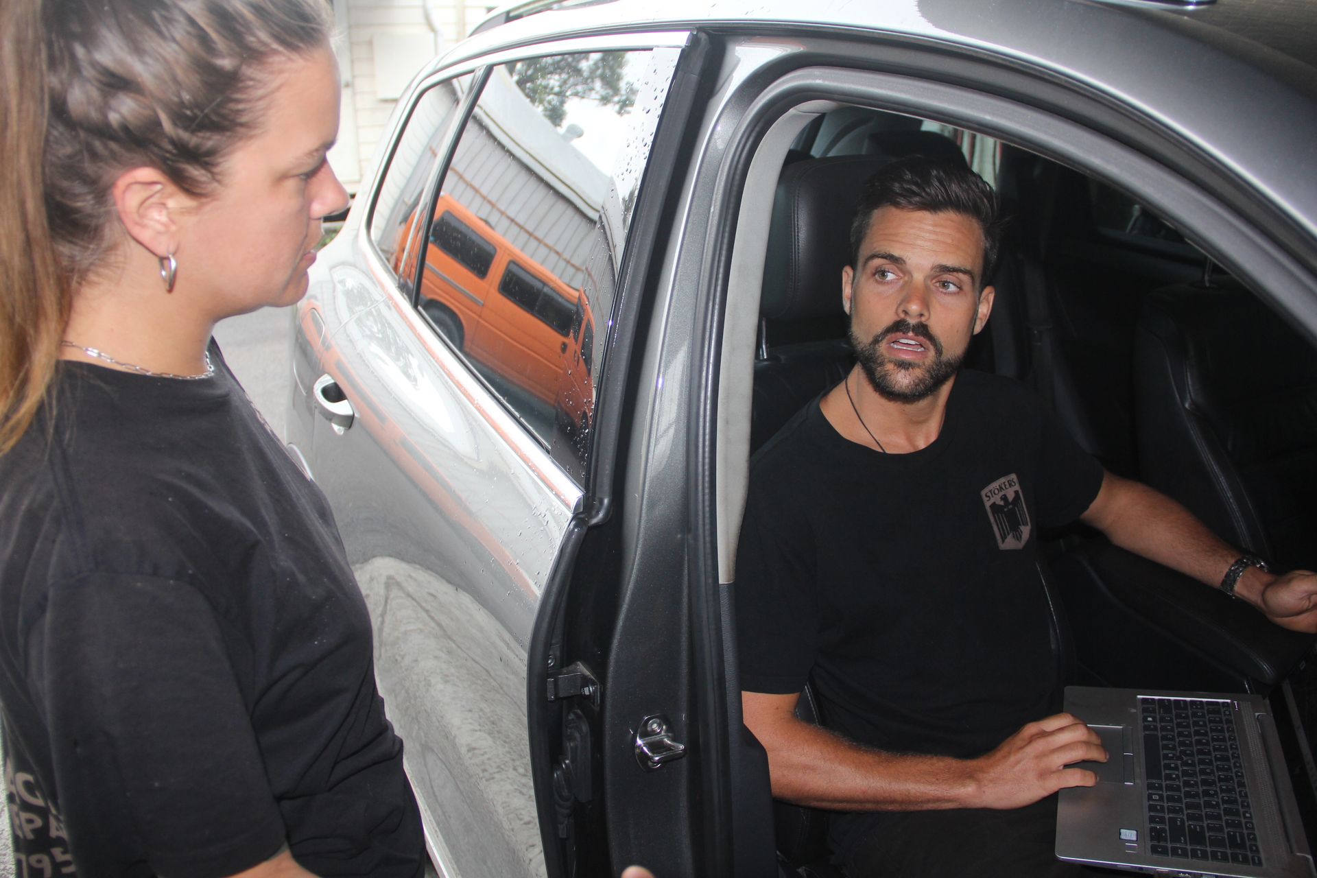 An employee is sitting in car with laptop while testing for errors — Stokers VW Mechanical Servicing & Repairs in Byron Bay, NSW