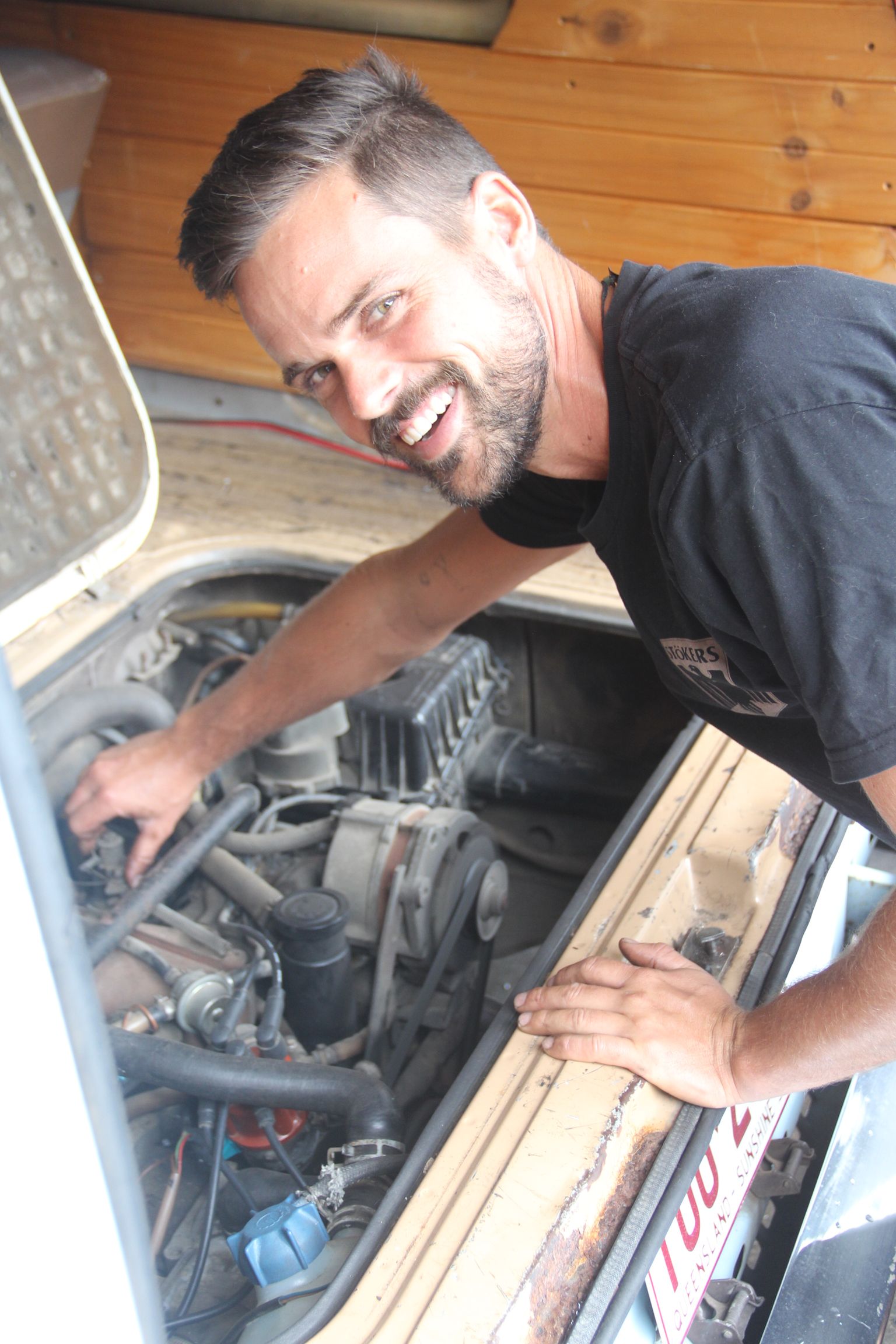 A Stokers Worker is looking at bonnet of car  — Stokers VW Mechanical Servicing & Repairs in Byron Bay, NSW
