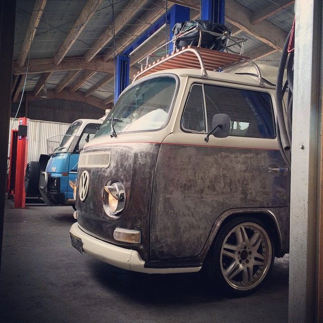 A Row of Volkswagen Vans Are Parked in a Garage — Stokers VW Mechanical Servicing & Repairs in Byron Bay, NSW