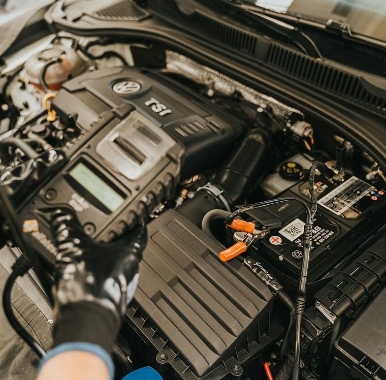 A Person is Working on the Engine of a Tdi Car — Stokers VW Mechanical Servicing & Repairs in Byron Bay, NSW