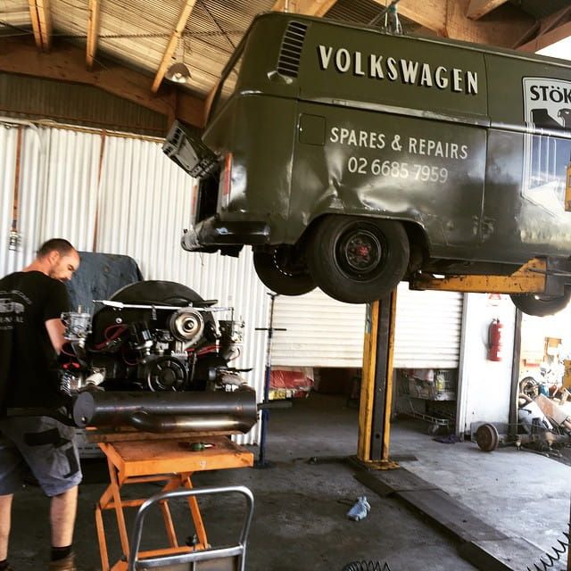 A Volkswagen Van is Sitting on a Lift in a Garage — Stokers VW Mechanical Servicing & Repairs in Byron Bay, NSW