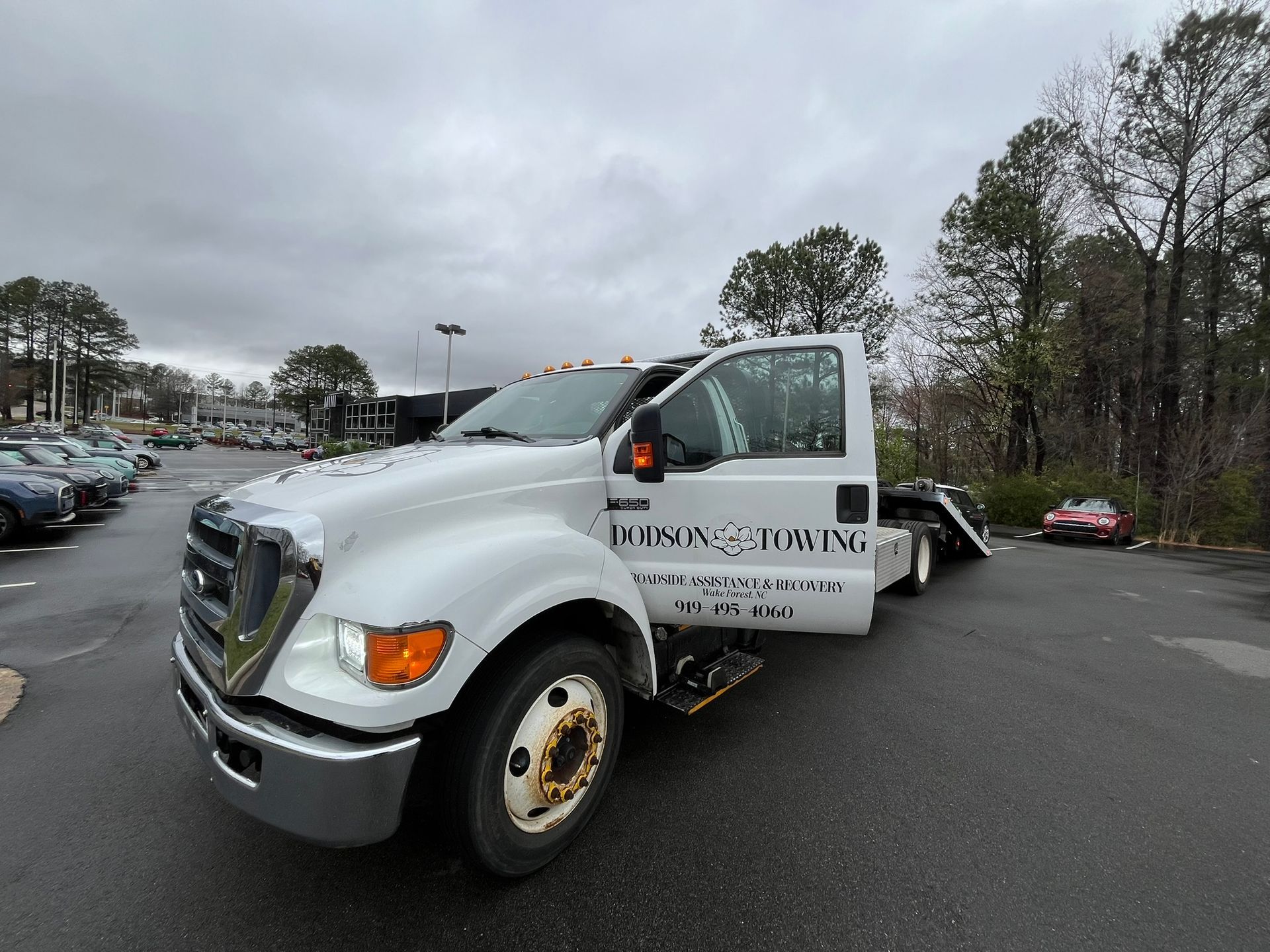 A man wearing a tow truck vest with the letter b on it