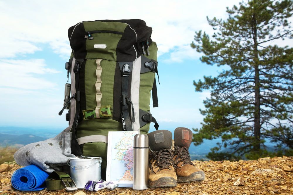 A Green Backpack Is Sitting On Top Of A Rocky Hill — Eclipse Hire In  Tablelands, QLD