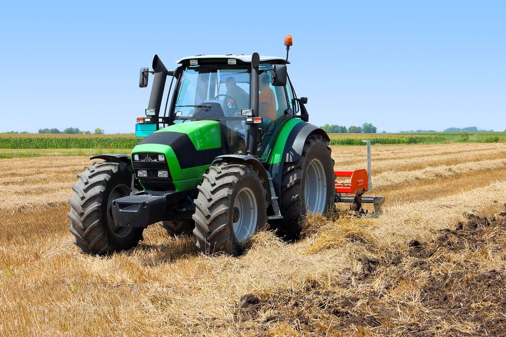 A Green Tractor Is Parked On The Side Of The Road — Eclipse Hire In Cairns, QLD